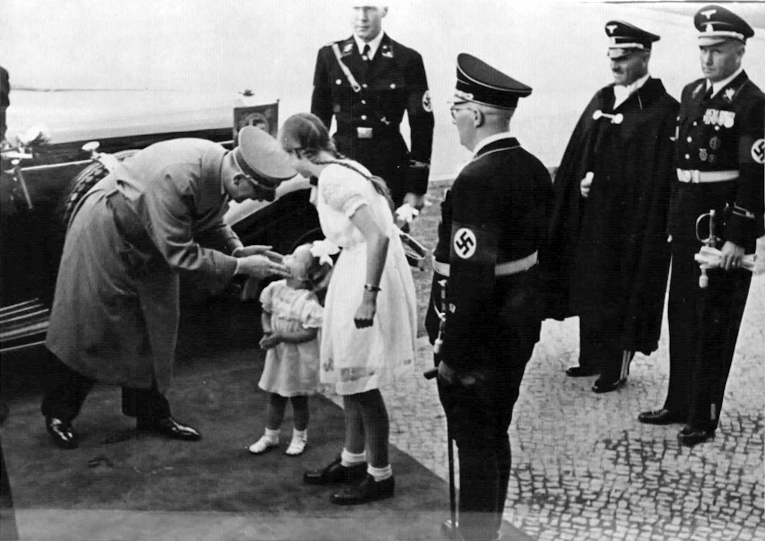 Adolf Hitler greets a little girl at his arrival in Dessau